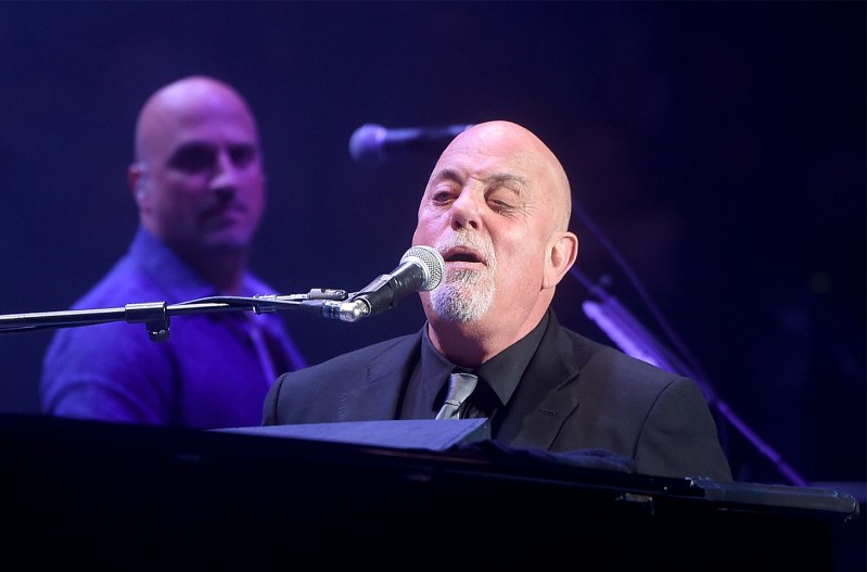 Billy Joel performing at his piano