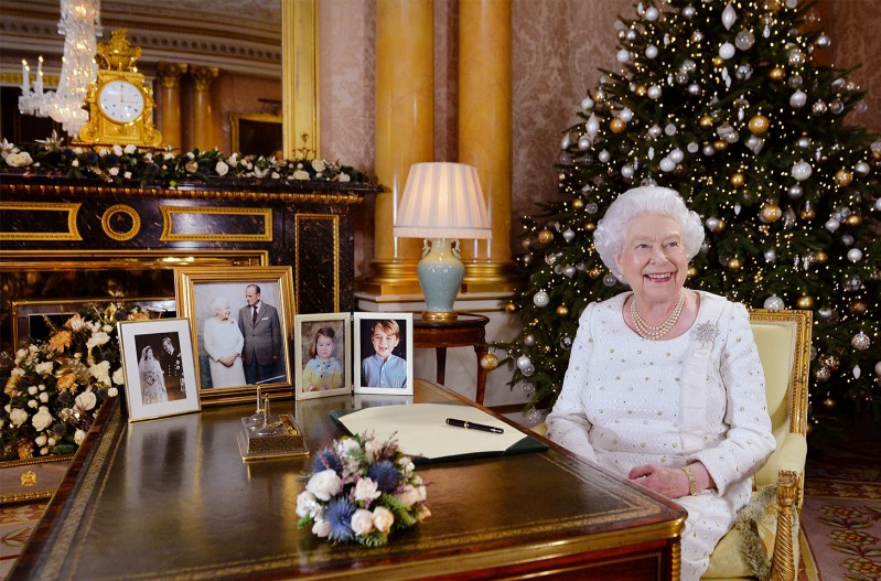 Queen Elizabeth sitting in front of a Christmas Tree