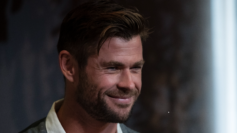 Chris Hemsworth wears a gray vest during an event for tourism in Australia