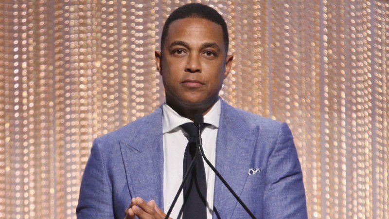 Don Lemon wears a blue suit as he makes remarks onstage