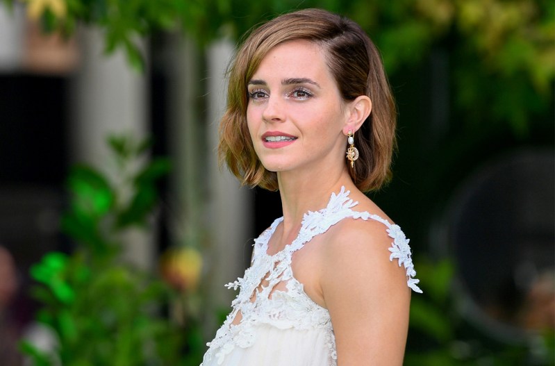 Emma Watson smiling in a white dress