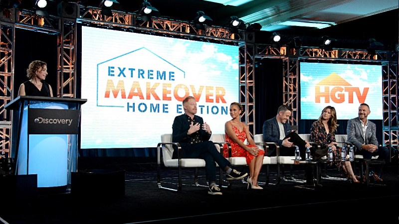 Several panelists sit on stage at an HGTV event