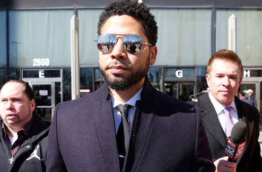 Jussie Smollett leaving court with mirrored sunglasses on