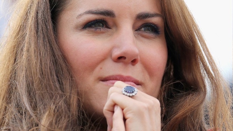 A close up of Kate Middleton with her blue engagement ring front and center