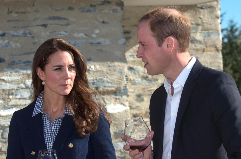 Kate Middleton looking at Prince William while both hold glasses of wine.