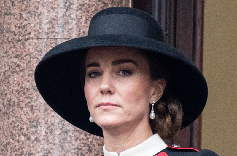 Kate Middleton in a black hat, looking serious