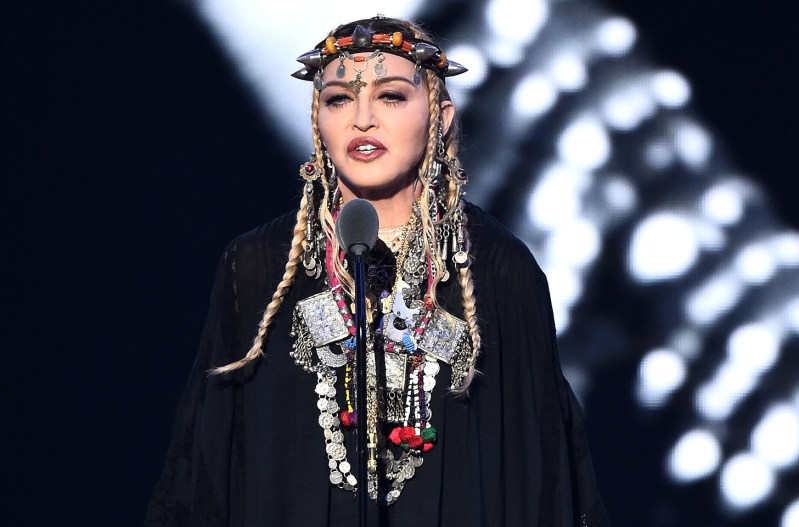Madonna on stage wearing south american inspiredheaddress