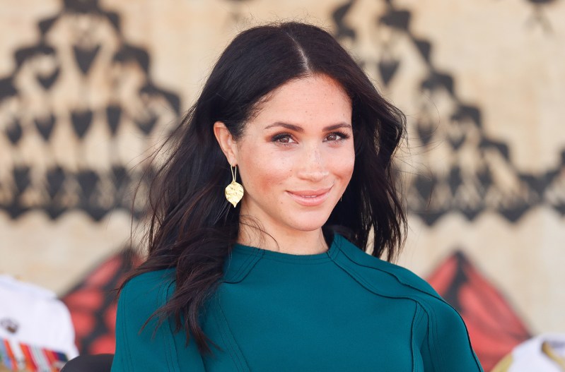 Meghan Markle in a green sweater, smiling