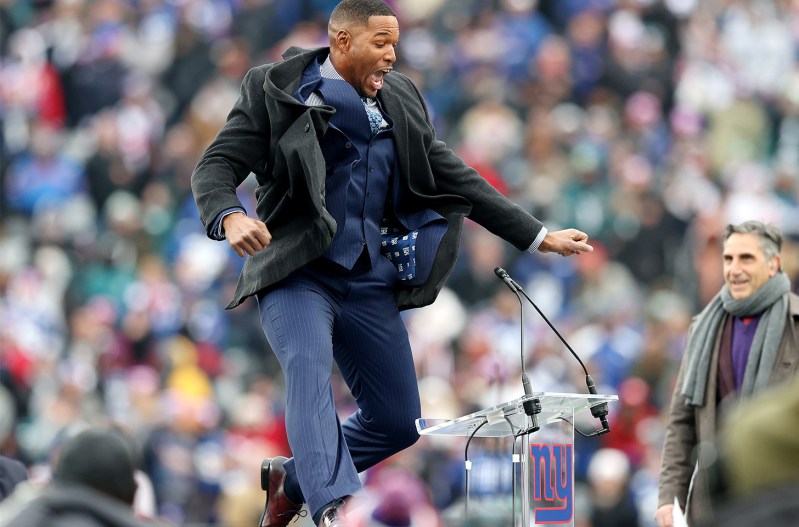 Michael Strahan jumping up in the air