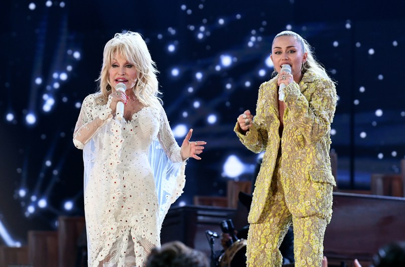 Miley Cyrus on the right, performing wih Dolly Parton