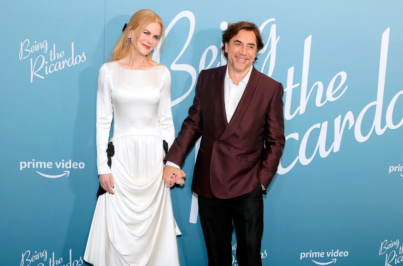 Nicole Kidman in all white, holding hands with Javier Bardem at the premiere of 'Being The Ricardos'