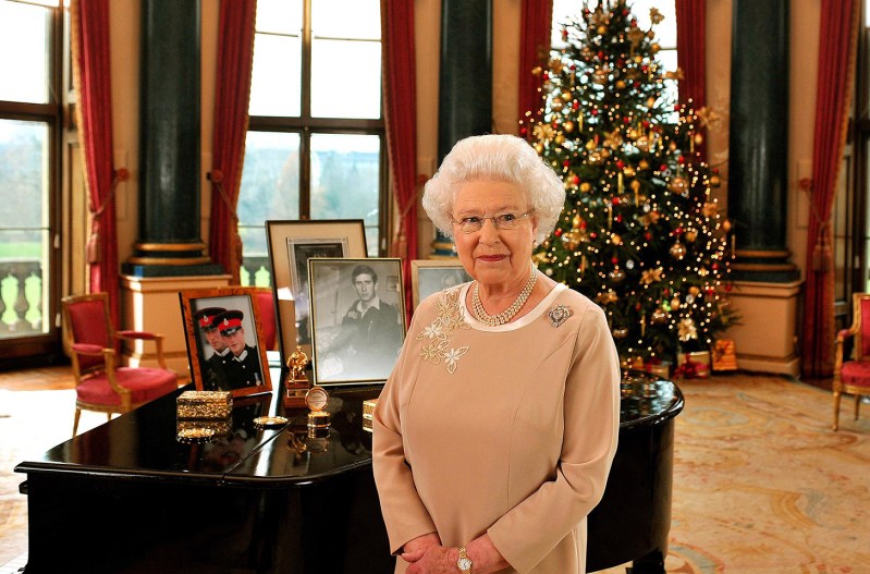 Queen Elizabeth standing in front of a Christmas tree