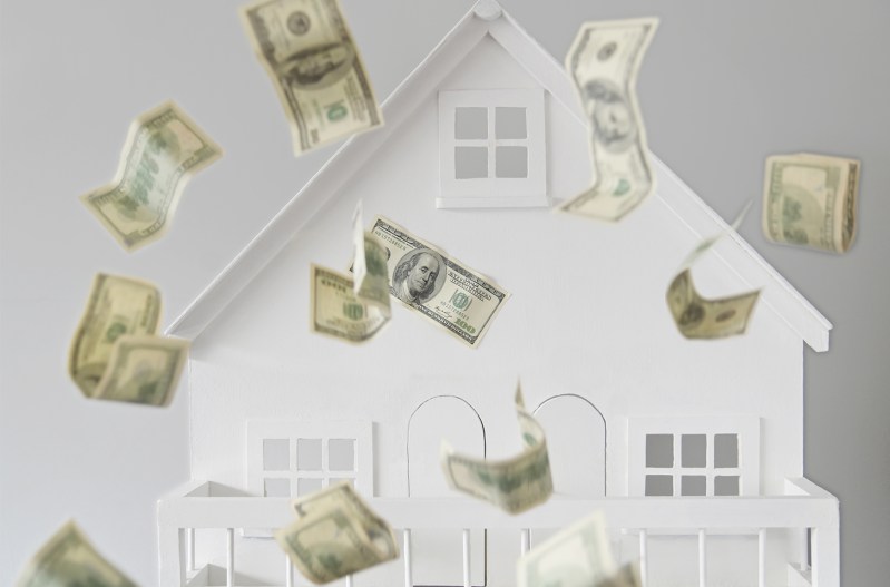 An illustration of a house with money flying in front of it