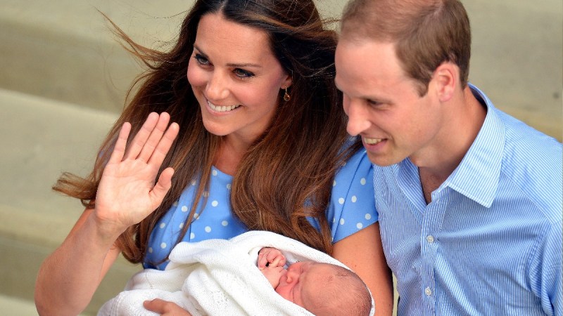 Kate Middleton and Prince William wave to well wishers as they hold their newborn baby