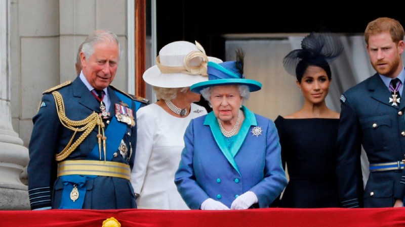 Several members of the British royal family, including Queen Elizabeth and Prince Charles, stand on a balcony
