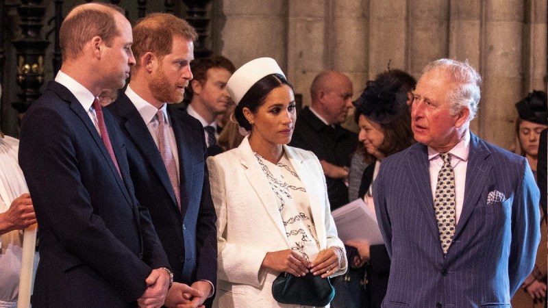 Prince William, Harry, and Charles stand with Meghan Markle indoors during a royal event