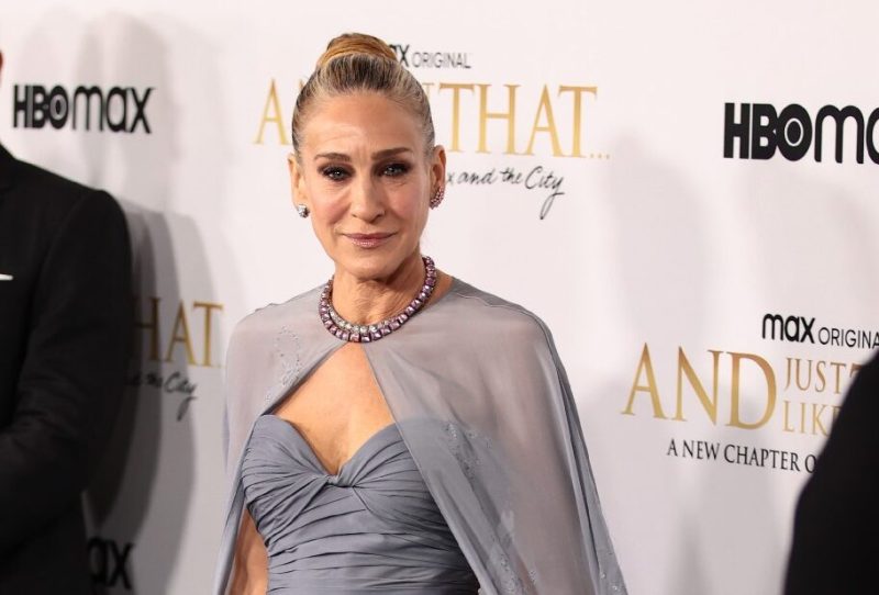 Sarah Jessica Parker wears a gray dress and stands near husband Matthew Broderick on the red carpet