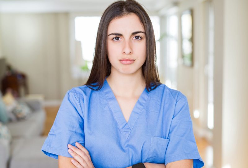 Young female nurse with arms crossed.