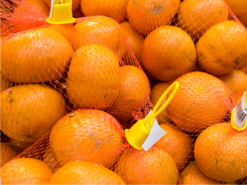 Mandarin oranges in plastic mesh fruit bags at the supermarket
