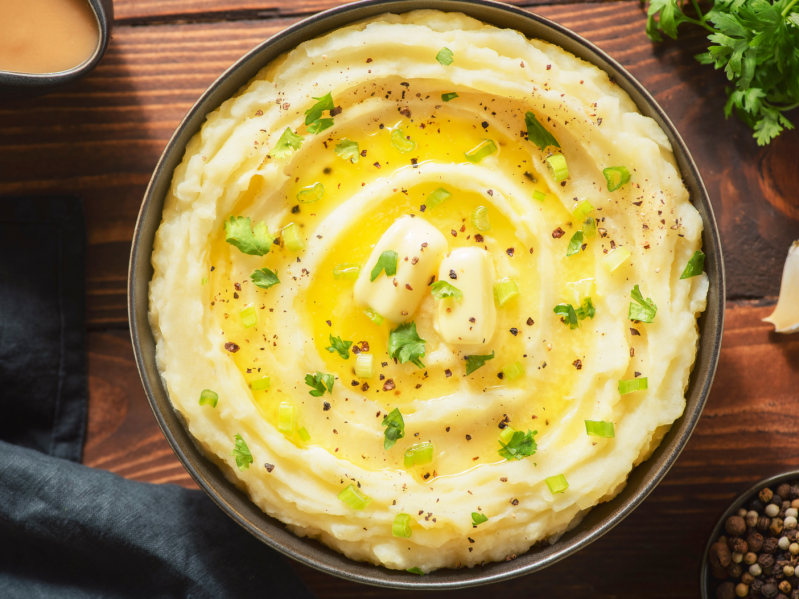 A bowl of creamy mashed potatoes with butter