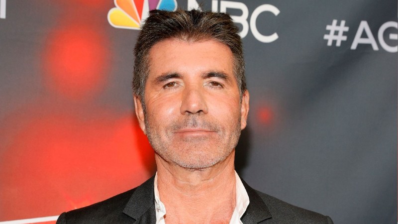 Simon Cowell wears a black suit on the red carpet