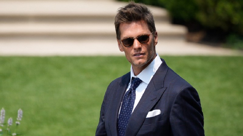 Tom Brady wears a dark suit and sunglasses as he attends a White House eveent