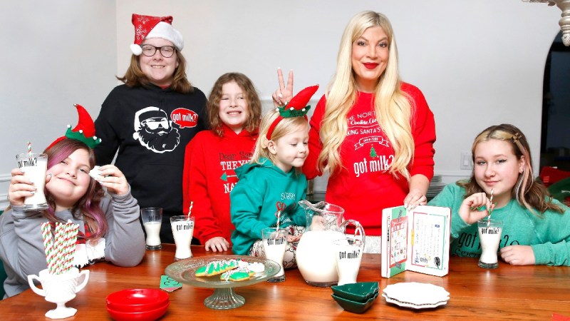 Tori Spelling wears festive pajamas with her five children while enjoying milk