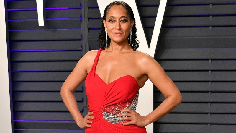 Tracee Ellis Ross wears a red dress while walking the red carpet