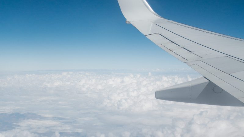 White airplane over the white sky