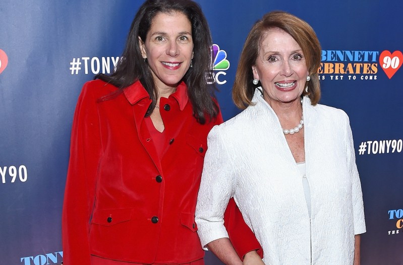 Alexandra Pelosi on the left in red, standing with her mother, Nancy Pelosi in white, on the right