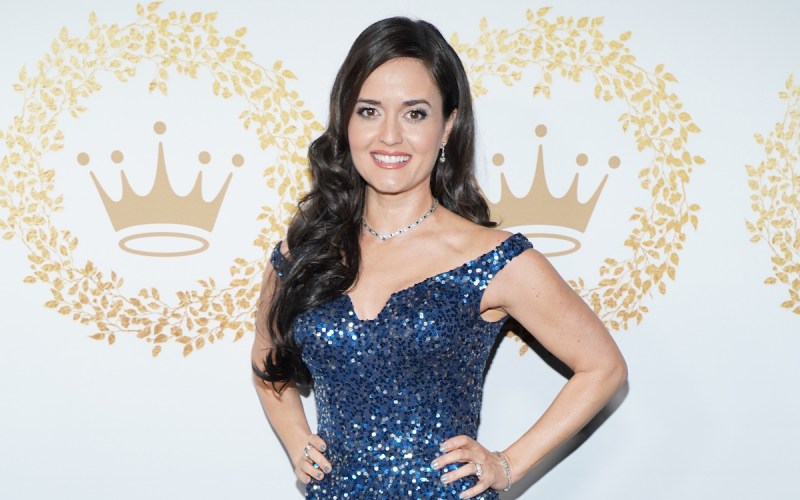 Danica McKellar smiling in a blue dress