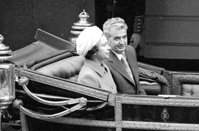 a black and white photo of Queen Elizabeth and Nicolae Ceaușescu in a carriage during the dictators visit