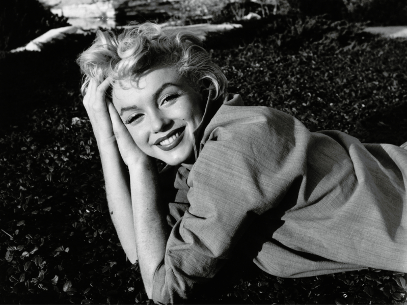 Black and white photo of Marilyn Monroe smiling at the camera