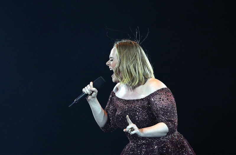 Adele performing in concert, now answering questions about canceling some