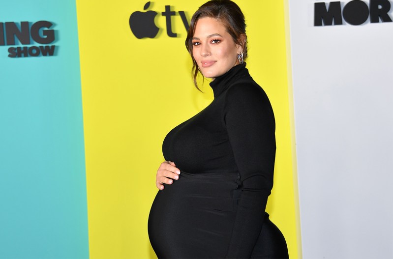 A pregnant Ashley Graham in a black dress.