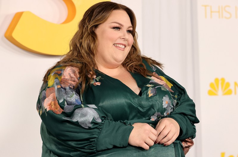 Chrissy Metz smiling in a green, floral dress.