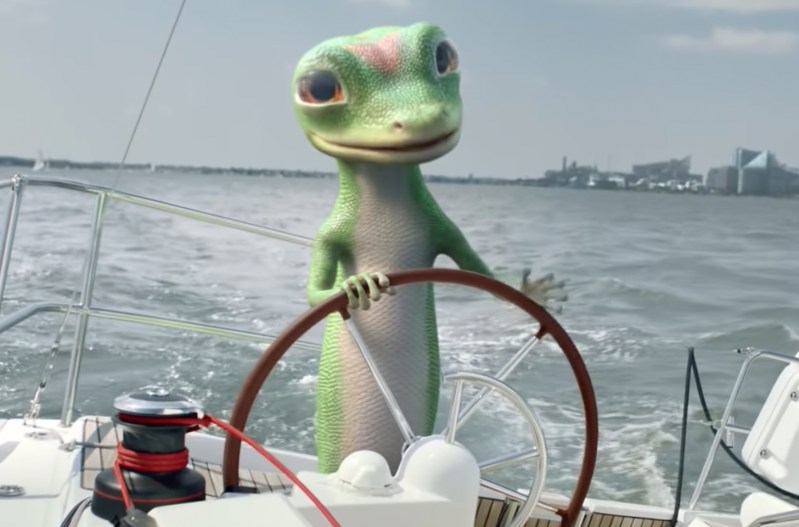 Screen shot of the Geico Gecko in a commercial, on a sail boat in a commercial