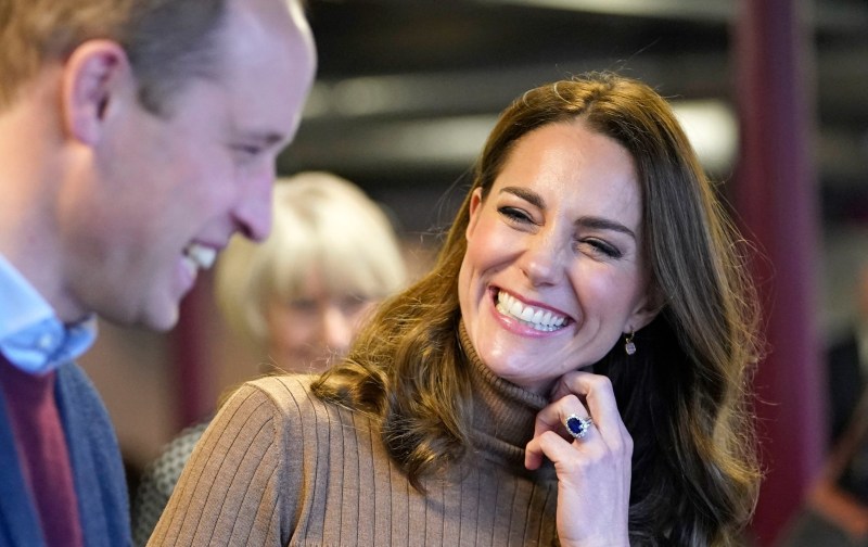 Kate Middleton laughs at husband Prince William while wearing a brown dress