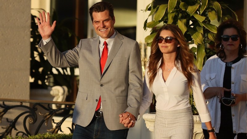 Matt Gaetz and wife Ginger Luckey walk hand in hand in Florida