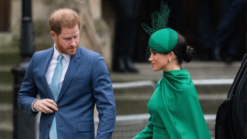 Prince Harry holds Meghan Markle's hand as the two attend a royal event