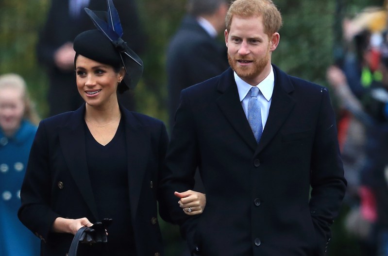 Meghan Markle (left) walking with Prince Harry
