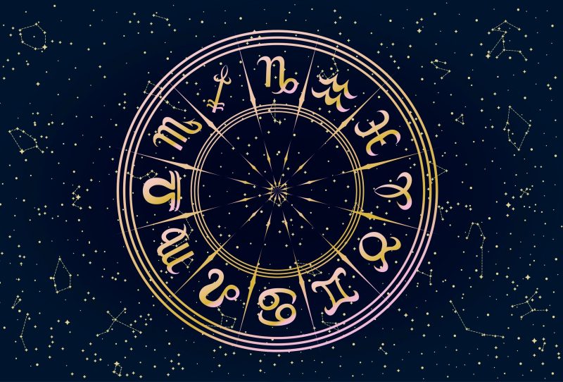 Gold outline of zodiac wheel on black starry background
