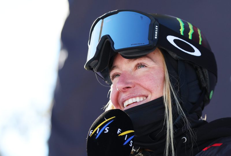 Jamie Anderson in her snowboard gear, smiling.