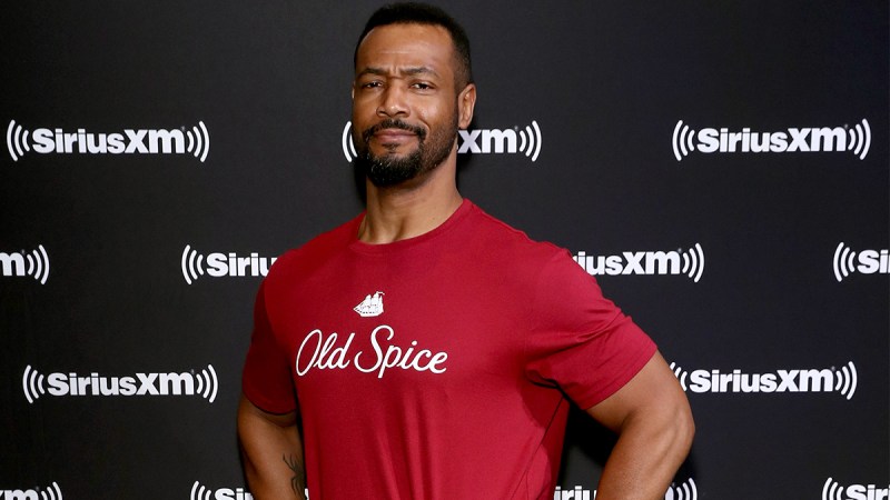 Isaiah Mustafa posing in an Old Spice tee-shirt at a SiriusXM event