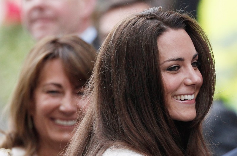 Kate Middleton on the foreground, smiling, Carole Middleton in the background, also smiling