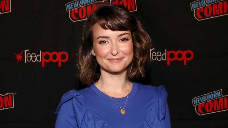 Milana Vayntrub smiling in a blue dress
