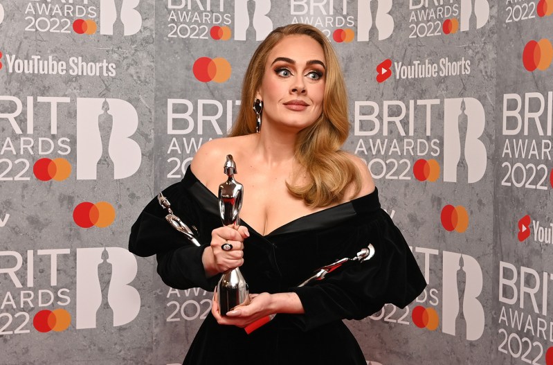 Adele makes a funny face while holding a BRIT award