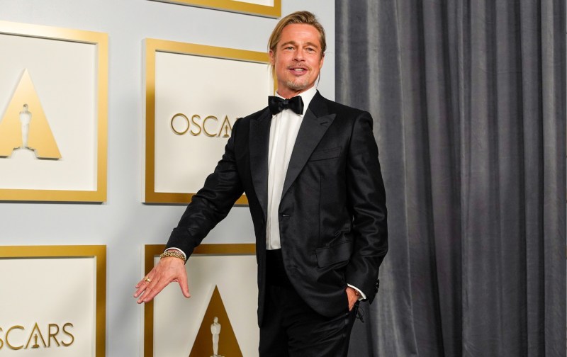Brad Pitt wears a black tux in the press room at the Oscars