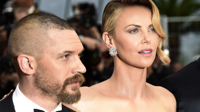 Charlize Theron on the right, posing with Tom Hardy at the Mad Max: Fury Road premiere