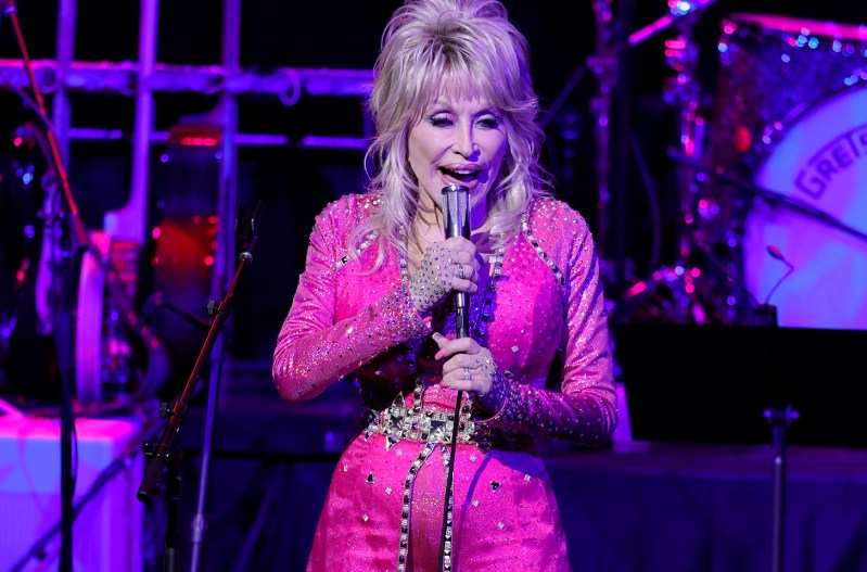 Dolly Parton in all pink, performing on stage
